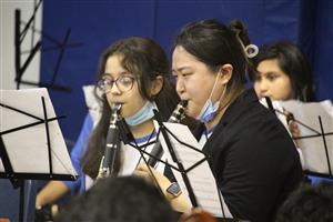 Two student playing woodwind instruments