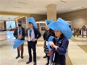 Students in blue foam cowboy hats